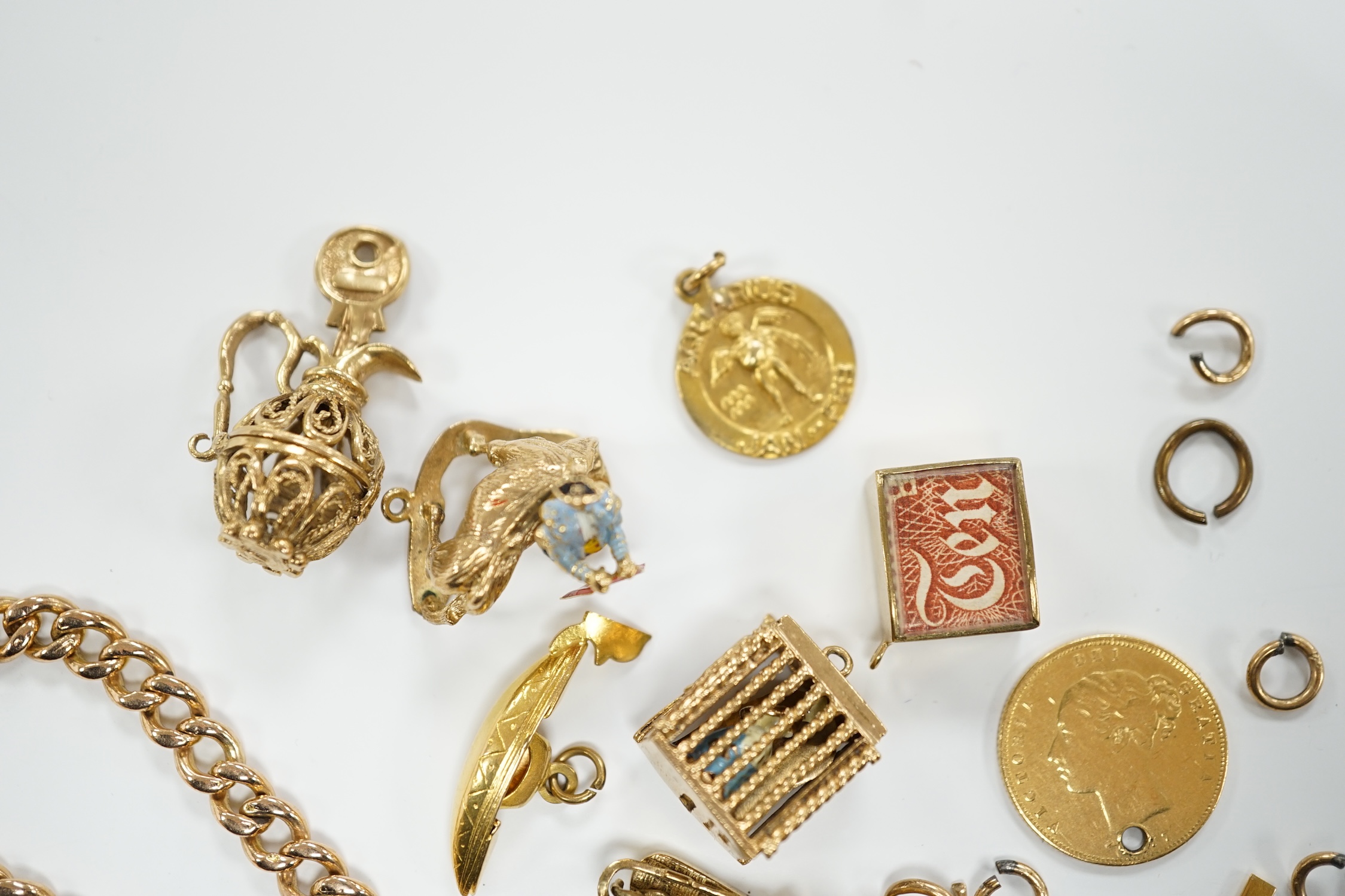 A 9ct gold curb link bracelet and eleven assorted mainly 9ct gold loose charms